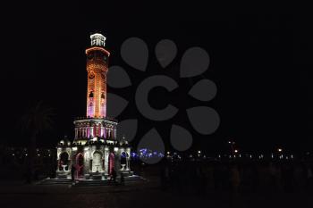 Clock tower on Konak Square at night, it was built in 1901 and accepted as the official symbol of Izmir City, Turkey