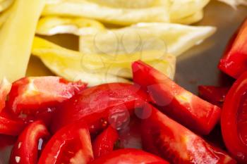 Sliced tomatoes and yellow bell peppers, macro photo with soft selective focus
