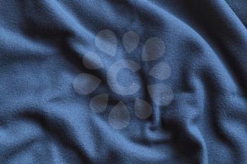 Texture of blue fleece, soft napped insulating fabric made of polyester, wavy pattern