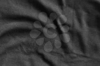 Texture of dark gray fleece, soft napped insulating fabric made from polyester, wavy pattern