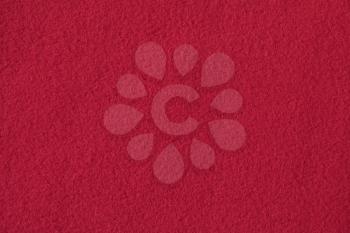 Texture of red fleece, soft napped insulating fabric made from polyester
