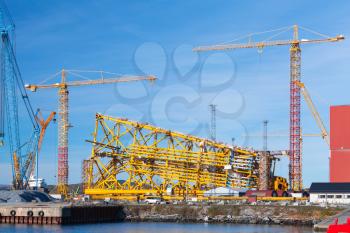 Oil production platform is under construction. Industrial landscape with cranes. Verdal, Norway