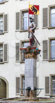 Vennerbrunnen fountain located in front of the old city hall or Rathaus of Bern, Switzerland. The statue, built in 1542 shows a Venner in full armour with his banner