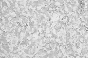 Concrete wall with white decorative relief stucco pattern, background photo texture
