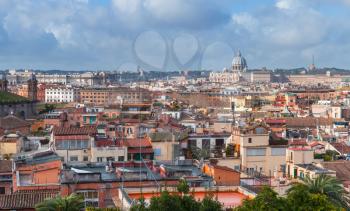 Skyline of old Rome with roofs and The Papal Basilica of St. Peter in the Vatican on the horizon, photo taken from the Pincian Hill, Italy