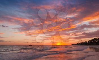 Colorful clouds in sunrise over Atlantic Ocean coast, Bavaro beach. Dominican Republic, coastal landscape