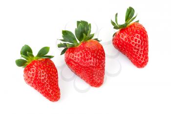 Three bright fresh strawberries isolated on white