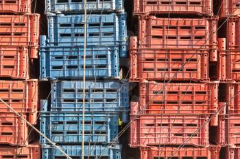 Empty plastic cargo boxes are stacked in a truck