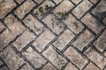 Old dark brick road pavement, abstract background texture