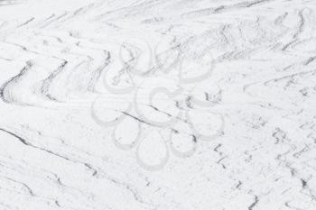 Abstract background texture of shining snowdrift with nice curved shadows