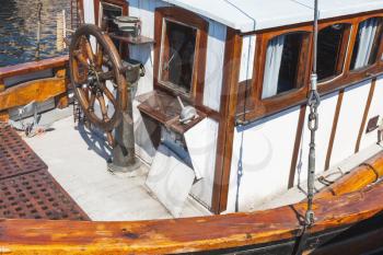 Wooden sailing ship bow fragment with steering wheel and control panel