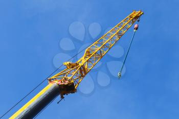 Telescopic crane boom with hook hanging on chain