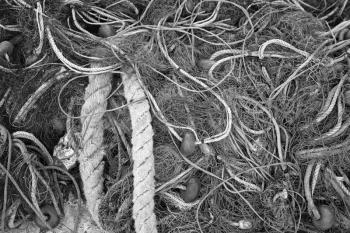 Old fishing net drying on pier in Greece, black and white background photo