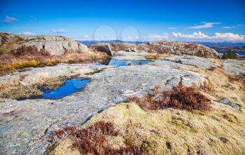 Northern Norway in springtime. Mountain landscape with small puddles on rocks