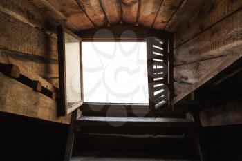 Empty attic window with white background in old grunge wooden interior