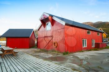 Norway, Vingvagen village. Red wooden fishing barns stand on the sea coast