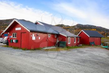 Norway, Snillfjord, Sor-Trondelag region, Vingvagen village. Red wooden fishing barns stand on the sea coast