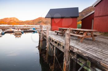 Norwegian red wooden barns stand on the sea coast. Snillfjord, Sor-Trondelag region, Vingvagen fishing village