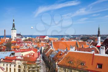 Old town of Tallinn panorama. Churches and living houses with red roofs