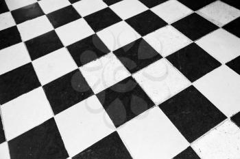 Vintage stone floor tiling with black and white checkered pattern