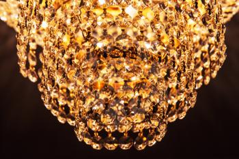 Round retro chandelier with crystal glass design elements, closeup photo
