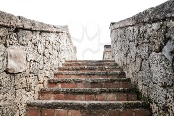 Ancient stone stairway goes up isolated on white background