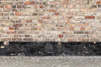 Abstract empty urban interior background with brick wall and cobblestone street tiling