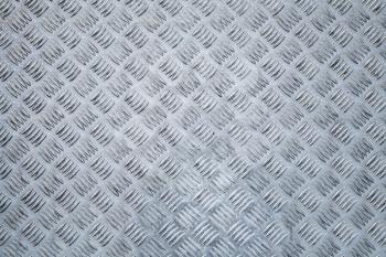 Blue shining metal floor surface with industrial diamond plate relief pattern
