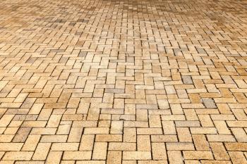 Yellow cobblestone road pavement, background photo with selective focus