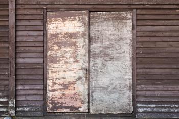 Closed door in old wooden wall, rural architecture detail