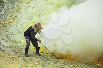 Sulfur miner inside crater of Ijen volcano, East Java, Indonesia