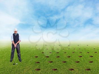Adult businessman plays golf with many holes 