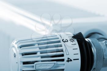 Closeup of heating radiator thermostat. Toned in blue