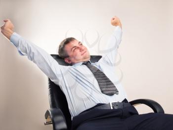 Office worker in a suit celebrates victory