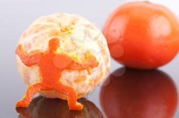 A strong man of peel holding big mandarin