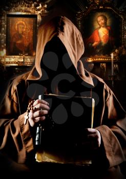 Portrait of medieval monk with bible in church