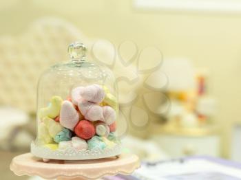 Small candies in nice room interior closeup