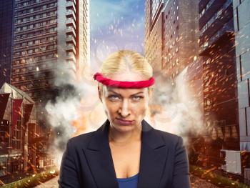 Furious businesswoman with a red bandage in the city 