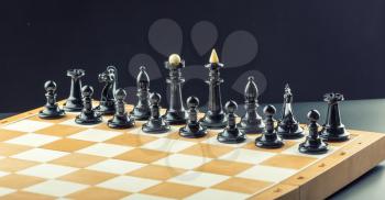 Black chess figures on the board ready to fight