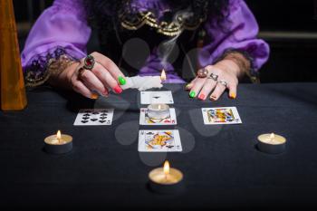 Sorceress telling fortunes using cards and candles