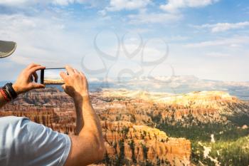 Traveler take pictures at monument valley. Blue sky on the background