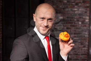 Contract killer in suit and red tie shows his fears and secrets. Special agent holds little toy duck in hand. Hired murderer wallpaper or background