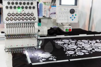 Sewing machine in work, textile fabric, nobody. Factory production, sew manufacturing, needlework technology