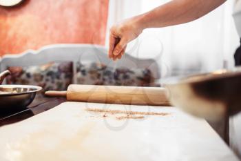 Male chef hand over dough, apple strudel cooking. Homemade sweet dessert, pastry preparation process