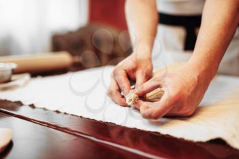 Male chef prepares apple strudel, bakery cooking. Homemade sweet dessert, preparation process