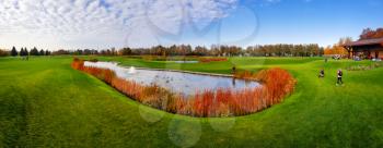 Pond in autumn park, panorama. October forest and lake, panoramic view, orange and yellow foliage on background