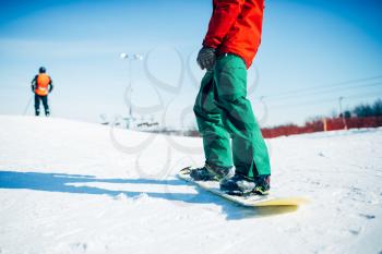 Snowboarder riding a snow hill. Winter extreme sport, active lifestyle. Snowboarding in mountains