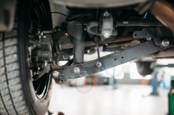 Suspension, closeup view from under the car, nobody. Automobile repair, vehicle maintenance, tire service