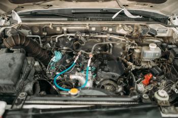 Car with opened hood, closeup view on engine, automobile service, motor diagnostic. Vehicle heart maintenance, auto-service