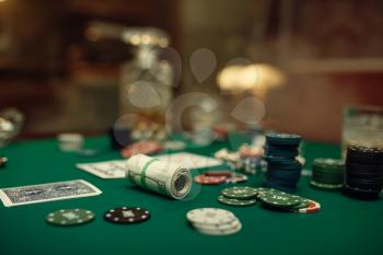 Poker concept, money bet, cards and chips on gaming table, whiskey and cigar in casino. Games of chance. Gambling house business